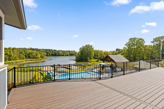 wooden terrace featuring a water view and a fenced in pool