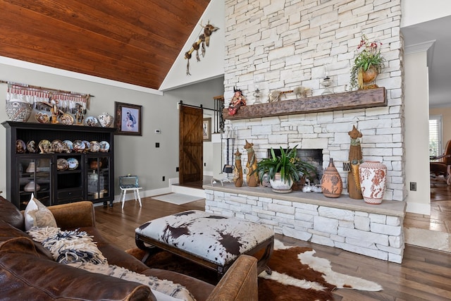 living room featuring hardwood / wood-style floors, high vaulted ceiling, wood ceiling, crown molding, and a barn door