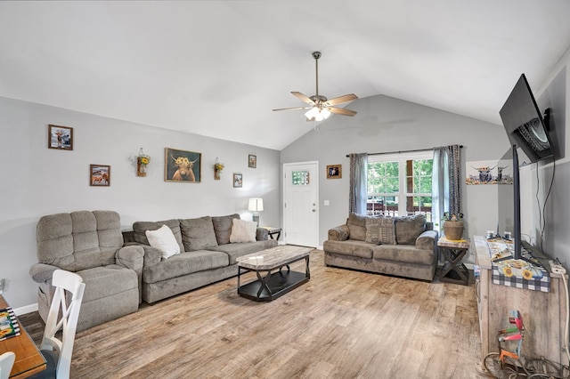 living room featuring ceiling fan, lofted ceiling, and light hardwood / wood-style flooring