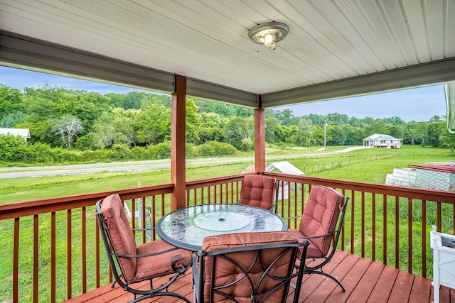 wooden deck featuring a lawn