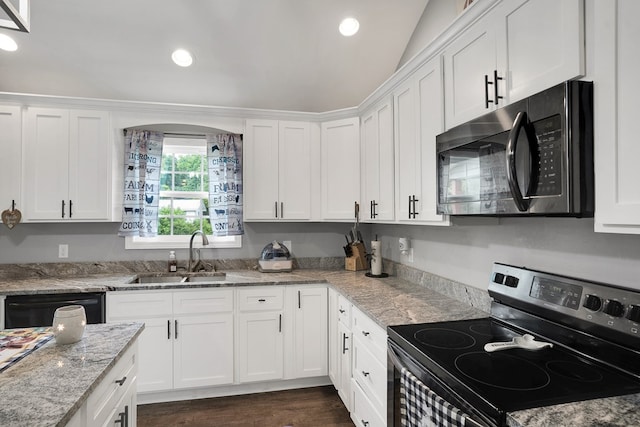 kitchen with sink, light stone counters, range with electric stovetop, black dishwasher, and white cabinets