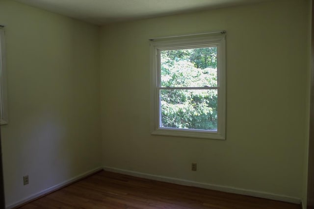 1722 Ball Ave, Dalton, GA 30720 - unfurnished room with baseboards, dark wood-style flooring, and plenty of natural light