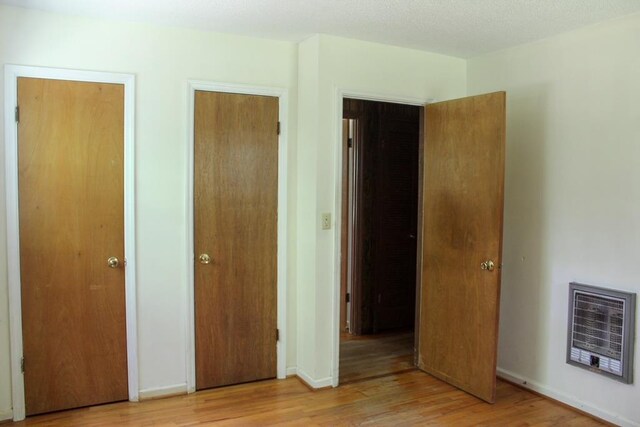 1722 Ball Ave, Dalton, GA 30720 - unfurnished bedroom with heating unit, light wood-style flooring, and baseboards