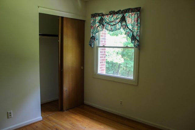 1722 Ball Ave, Dalton, GA 30720 - unfurnished bedroom featuring baseboards, wood finished floors, and a closet