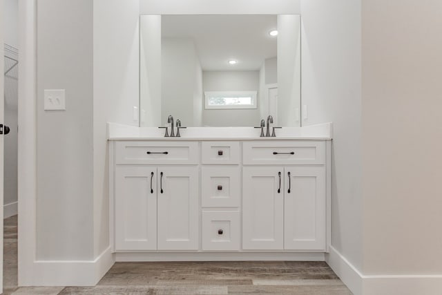 bathroom featuring vanity and hardwood / wood-style flooring