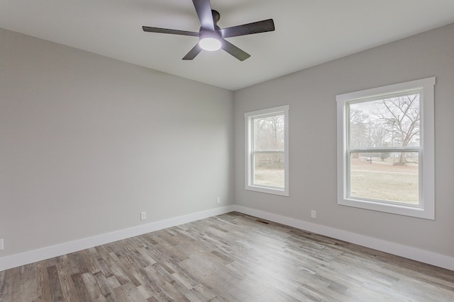 empty room with light hardwood / wood-style floors and ceiling fan