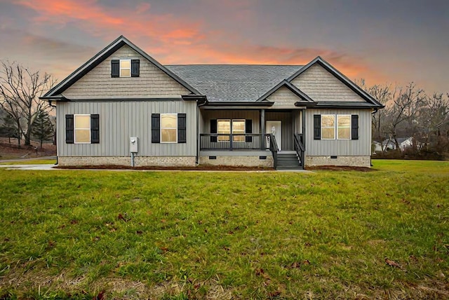 view of front of property featuring a porch and a lawn