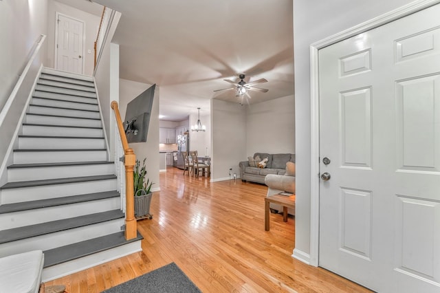 1521 Ashton Woods Way, Dalton, GA 30720 - entrance foyer with baseboards, stairs, light wood-style floors, and ceiling fan with notable chandelier