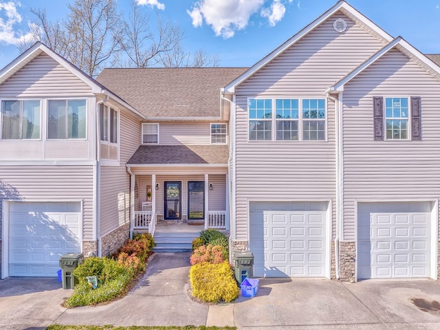 1521 Ashton Woods Way, Dalton, GA 30720 - view of front of home featuring an attached garage, stone siding, driveway, covered porch, and a shingled roof