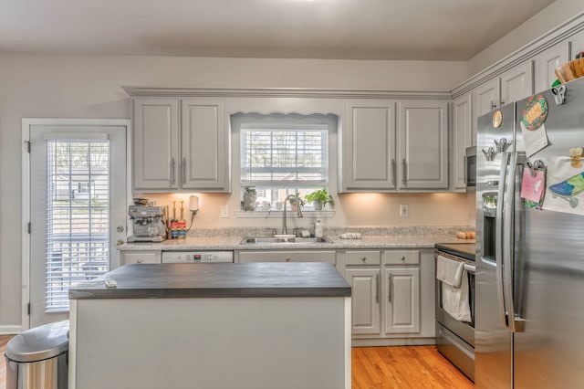 1521 Ashton Woods Way, Dalton, GA 30720 - kitchen featuring stainless steel appliances, a center island, gray cabinetry, a sink, and light wood-style flooring