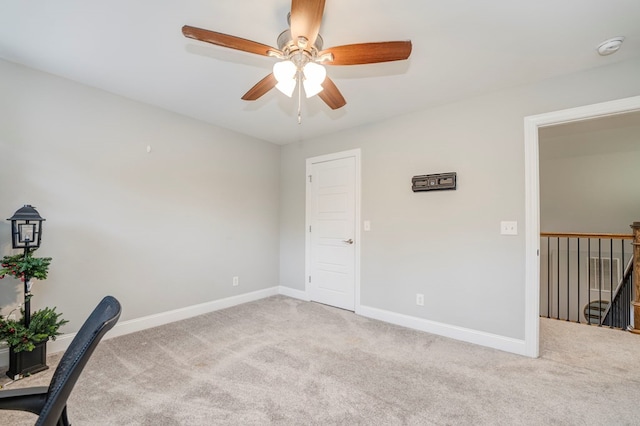 unfurnished office featuring light colored carpet and ceiling fan