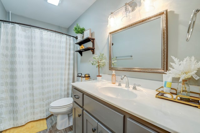 bathroom featuring vanity, hardwood / wood-style floors, toilet, and a shower with shower curtain