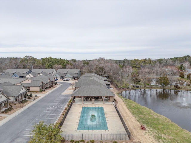 view of swimming pool with a patio and a water view