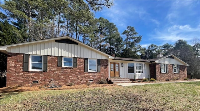 ranch-style house featuring board and batten siding, crawl space, and brick siding