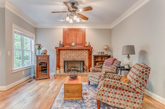 27 Bluff Mountain Dr, Rome, GA 30165 - living area with light wood-style floors, ceiling fan, a fireplace, baseboards, and ornamental molding