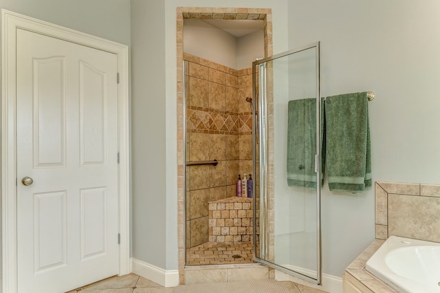 27 Bluff Mountain Dr, Rome, GA 30165 - full bathroom featuring a shower stall, a bath, tile patterned flooring, and baseboards