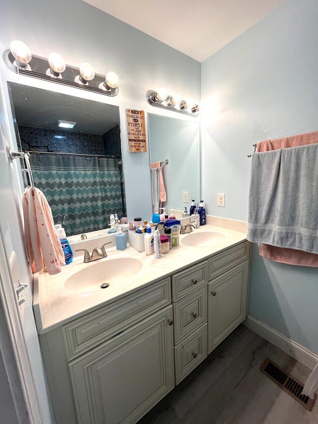 609 Charles St, Dalton, GA 30720 - full bathroom featuring double vanity, wood finished floors, and curtained shower