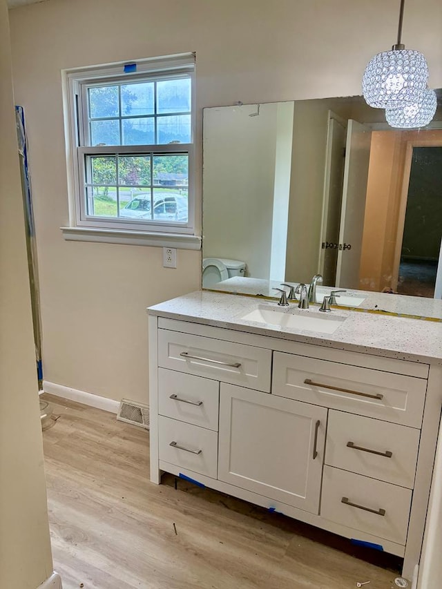 139 Hills Dr, Cohutta, GA 30710 - bathroom with vanity, wood finished floors, a chandelier, and baseboards
