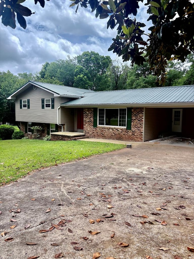 139 Hills Dr, Cohutta, GA 30710 - split level home featuring brick siding, driveway, a front yard, metal roof, and a carport