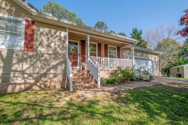 single story home with covered porch, an attached garage, and a front lawn