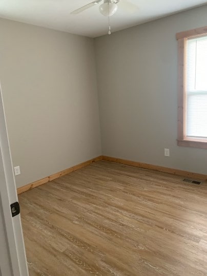 unfurnished room featuring ceiling fan and light hardwood / wood-style flooring