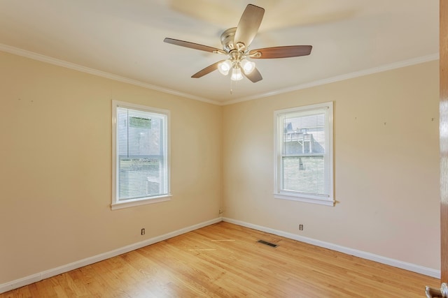 unfurnished room with a healthy amount of sunlight, light wood-style flooring, and baseboards