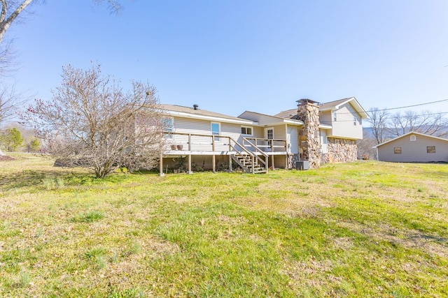 back of house featuring a deck, central AC unit, stairway, and a yard