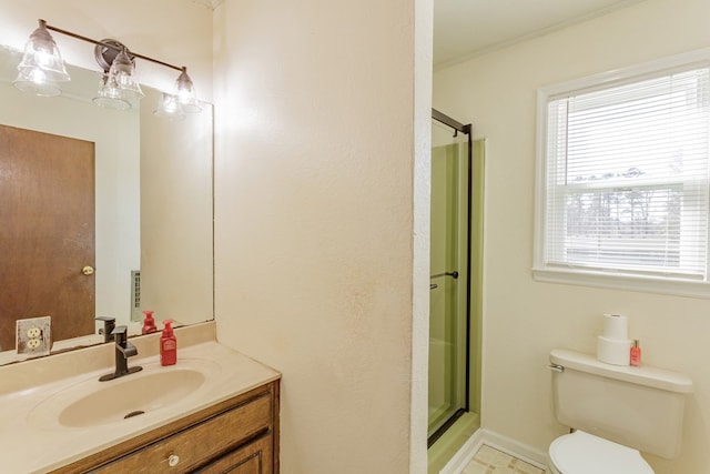 bathroom featuring toilet, a stall shower, and vanity