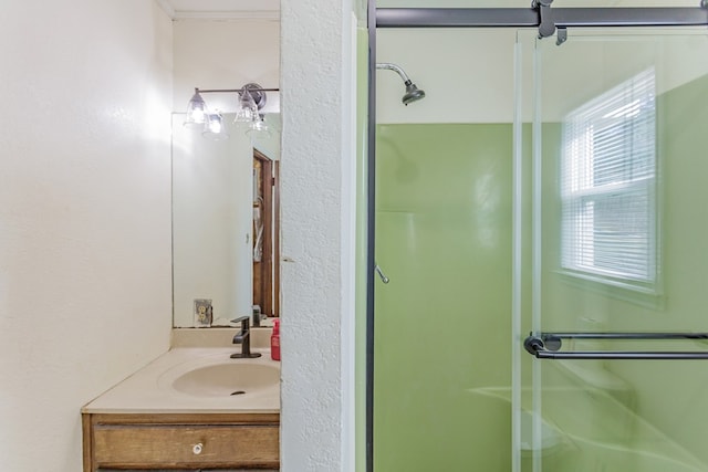 bathroom with vanity, a stall shower, and ornamental molding