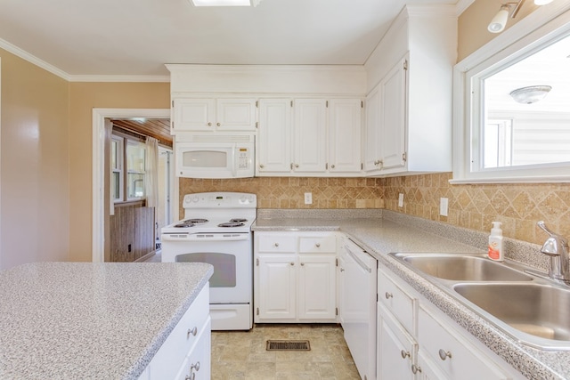 kitchen with a sink, white appliances, crown molding, light countertops, and decorative backsplash