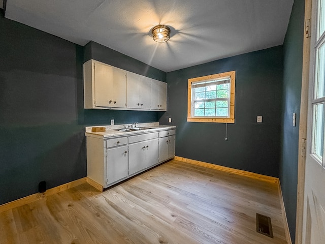 410 Anderson Ave, Dalton, GA 30721 - kitchen featuring white cabinets, light wood-style flooring, and light countertops