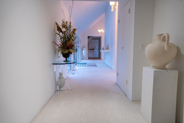 hallway featuring light colored carpet