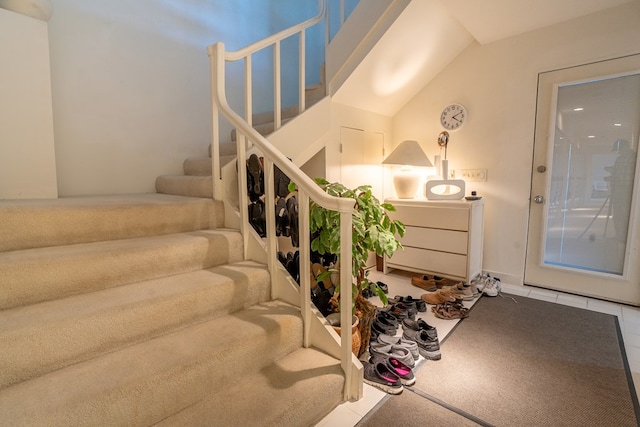 stairway with tile patterned floors