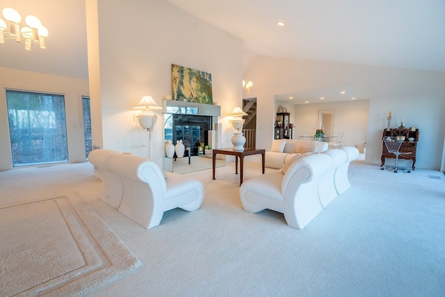 living room featuring high vaulted ceiling, light colored carpet, and a chandelier