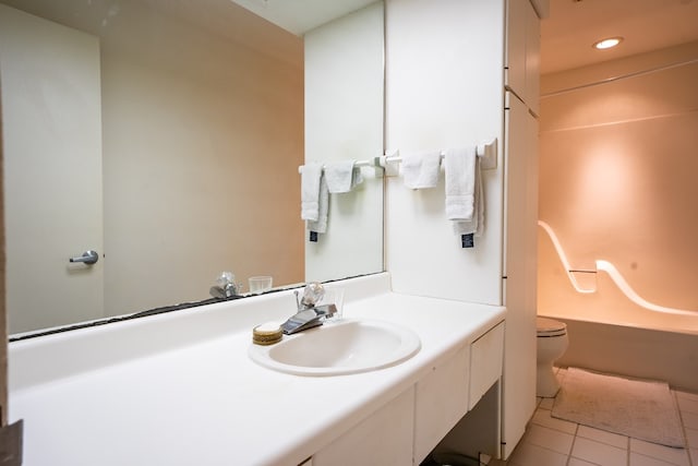 full bathroom featuring bathtub / shower combination, vanity, toilet, and tile patterned flooring