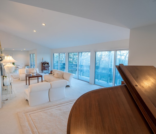 living room with lofted ceiling and light carpet