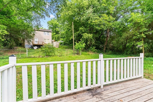 deck featuring a yard and fence