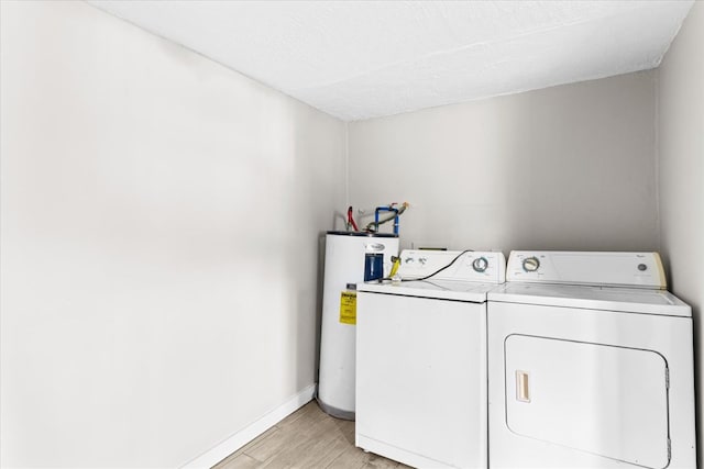 laundry room featuring baseboards, washer and clothes dryer, water heater, laundry area, and light wood-style floors