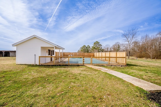 view of yard featuring a swimming pool and a wooden deck