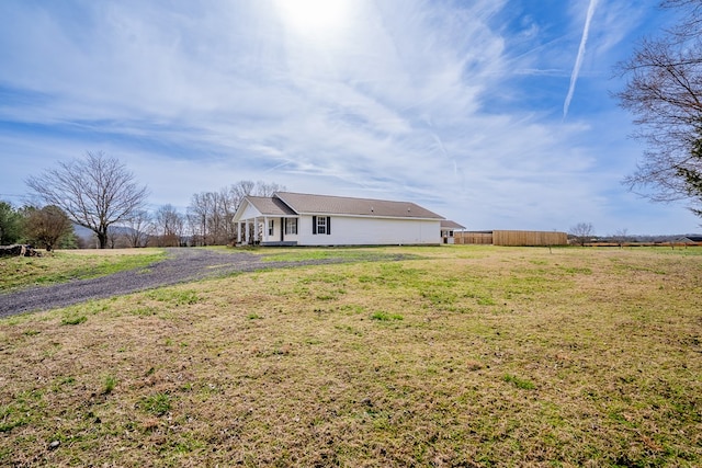 exterior space with fence and a yard