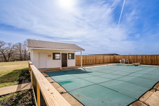 view of swimming pool with an outbuilding, fence, and a fenced in pool