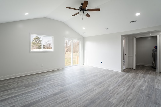 unfurnished living room with lofted ceiling, visible vents, a ceiling fan, light wood-type flooring, and baseboards