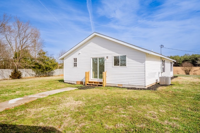 back of property featuring entry steps, central AC unit, a lawn, crawl space, and fence