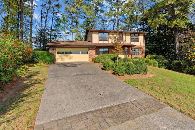 view of front of home with a garage and a front lawn