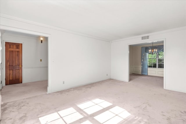 unfurnished room featuring ornamental molding, light carpet, and a notable chandelier