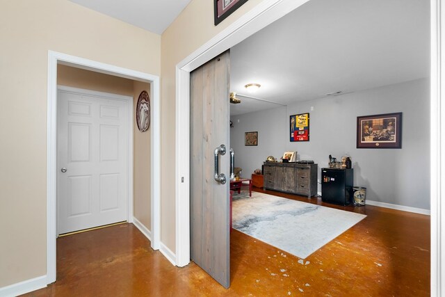 foyer with finished concrete flooring and baseboards