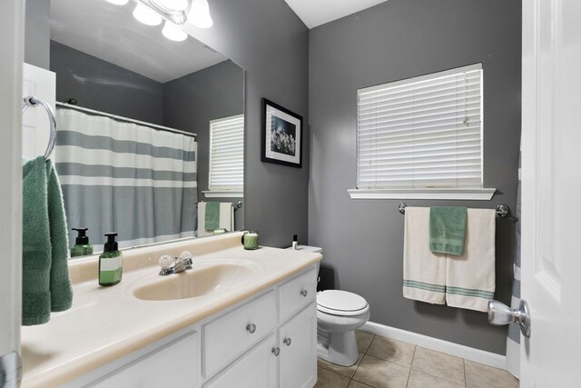 full bathroom featuring tile patterned floors, toilet, curtained shower, baseboards, and vanity