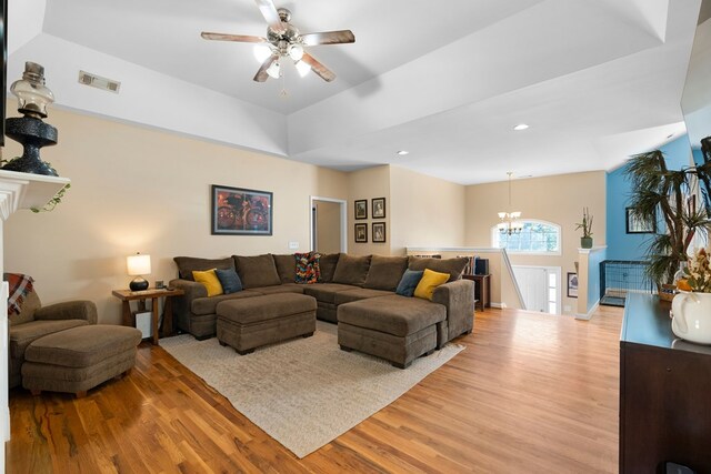 living room featuring recessed lighting, visible vents, light wood-style floors, and ceiling fan with notable chandelier