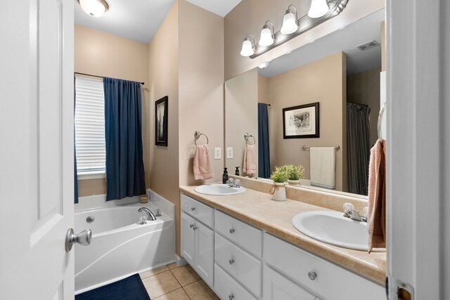 full bathroom featuring a sink, a bath, double vanity, and tile patterned flooring