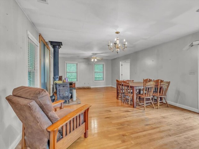 4978 Standifer Rd, Cohutta, GA 30710 - living area with a wood stove, light wood-style floors, ceiling fan, a chandelier, and baseboards